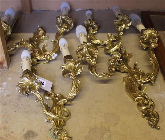 Two pairs of Louis XV style gilt metal two branch wall lights